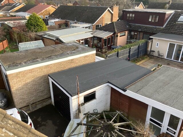 Flat roof repair of a garage of a house in Kettering, Northamptonshire.